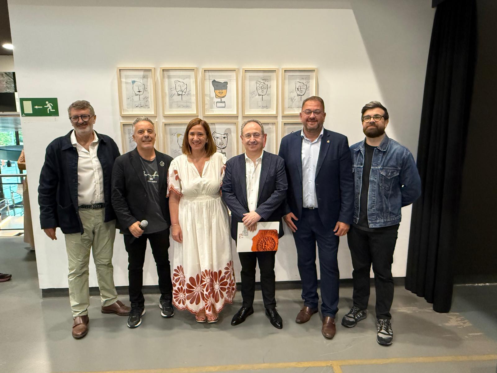 El director del festival, entre los alcaldes de Mérida e Irún, junto a responsables de Terracota Mérida, el museo de Irún y el gerente del Consorcio del festival ante varios dibujos de las máscaras que forman parte de la exposición Ars Factum